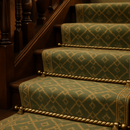 Antique brass spiral stair rods with ball finials on Edwardian staircase with sage green patterned runner
