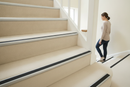 Heavy duty carpet stair nosing with White insert — installed on UK carpeted staircase, anti-slip protection over carpet