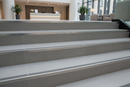 Semi-rounded bullnose stair nosing on upmarket UK hotel or office tiled staircase - elegant step edge protection