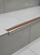 Retro-fit stainless steel stair nosing R11 Nut Brown RAL 8007 tread TREP-GK installed on stone stairs