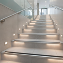 Anti-slip aluminium stair nosing 46mm x 30mm on commercial tiled UK building staircase - professional installation