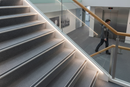 Heavy duty aluminium carpet stair nosing on commercial carpet tile staircase in UK office or hotel