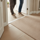 49mm wide aluminium door threshold strip in Champagne — installed between floors at UK home doorway with person using it