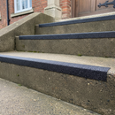 Black GRP anti-slip nosing on external concrete steps — UV stable outdoor permanent installation