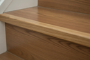 Close-up of uPVC wood effect stair nosing installed at stair tread edge - 30mm x 30mm profile oak finish