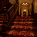 Antique brass plain stair rods with ball finials on Victorian staircase with red gold patterned runner