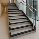 Black anti-slip PVC stair nosing installed on all steps of modern UK commercial staircase