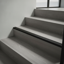 Matt Black NAS aluminium stair nosing on minimalist grey LVT staircase in contemporary UK home