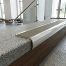Aluminium bullnose stair nosing cut to size, fitted to a concrete step edge in an office stairwell