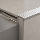 Close-up render of tile-in aluminium straight edge nosing with ribbed silver tread on a tiled step