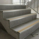 Aluminium tile-in stair nosing with a beige anti-slip PVC insert fitted along the edge of tiled steps