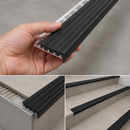 Black replaceable anti-slip insert in wide 35mm aluminium stair nosing profile