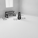 White rubber gym flooring roll installed in a bright home gym with dumbbell racks and free weights
