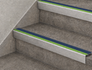 Cobalt blue and green slimline insert stair nosings fitted to two grey stone-effect steps