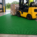 Forklift truck on green GRP anti-slip grating panels in warehouse loading bay