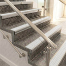 Raked back nosings with polar grey ribbed inserts on mottled stone steps, viewed along the flight