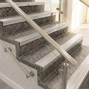 Polished aluminium raked back nosings with matching ribbed inserts on mottled stone steps