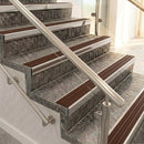 Square front aluminium stair nosings with rustic brown ribbed inserts on mottled stone steps