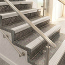Satin aluminium raked back nosings with matching ribbed inserts on mottled stone steps