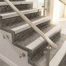 Satin aluminium raked back nosings with matching ribbed inserts on mottled stone steps