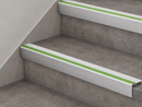 White and green insert stair nosings fitted to two grey concrete-effect steps