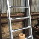 Conformable anti-slip tape on metal ladder rungs — wraps around curved rung surface