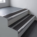 Polished aluminium bullnose stair nosing 66.5x30mm with Black Anodised Aluminium insert fitted on an office stair