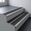 Aluminium bullnose stair nosing 66.5x30mm with Black Castellated insert fitted on an office stair