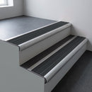 Mill aluminium bullnose stair nosing 66.5x30mm with Black Castellated insert fitted on an office stair