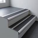 Aluminium bullnose stair nosing 66.5x30mm with Black Olympic Grip insert fitted on an office stair