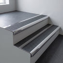 Polished aluminium bullnose stair nosing 66.5x30mm with Black Olympic Grip insert fitted on an office stair