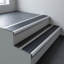 Aluminium bullnose stair nosing 66.5x30mm with Black Smooth Textured insert fitted on an office stair