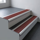 Aluminium bullnose stair nosing 66.5x30mm with Claret Castellated insert fitted on an office stair