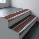 Polished aluminium bullnose stair nosing 66.5x30mm with Claret Castellated insert fitted on an office stair