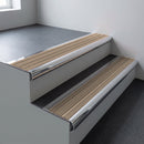 Polished aluminium bullnose stair nosing 66.5x30mm with Fawn Castellated insert fitted on an office stair