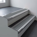Polished aluminium bullnose stair nosing 66.5x30mm with Flint Castellated insert fitted on an office stair