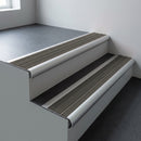 Aluminium bullnose stair nosing 66.5x30mm with Granite Castellated insert fitted on an office stair