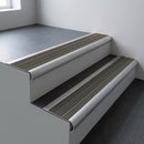 Mill aluminium bullnose stair nosing 66.5x30mm with Granite Castellated insert fitted on an office stair