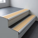 Aluminium bullnose stair nosing 66.5x30mm with Ivory Castellated insert fitted on an office stair