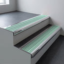 Polished aluminium bullnose stair nosing 66.5x30mm with Jade Castellated insert fitted on an office stair