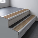 Mill aluminium bullnose stair nosing 66.5x30mm with Light Bronze Aluminium insert fitted on an office stair