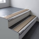 Polished aluminium bullnose stair nosing 66.5x30mm with Light Bronze Aluminium insert fitted on an office stair