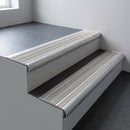 Mill aluminium bullnose stair nosing 66.5x30mm with Light Grey Castellated insert fitted on an office stair