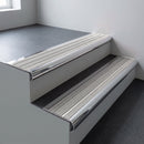Polished aluminium bullnose stair nosing 66.5x30mm with Light Grey Castellated insert fitted on an office stair