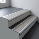 Aluminium bullnose stair nosing 66.5x30mm with Light Grey Smooth Textured insert fitted on an office stair