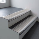 Polished aluminium bullnose stair nosing 66.5x30mm with Light Grey Smooth Textured insert fitted on an office stair
