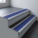 Aluminium bullnose stair nosing 66.5x30mm with Mid Blue Castellated insert fitted on an office stair