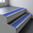 Mill aluminium bullnose stair nosing 66.5x30mm with Mid Blue Castellated insert fitted on an office stair