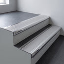 Polished aluminium bullnose stair nosing 66.5x30mm with Mill Aluminium insert fitted on an office stair