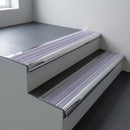 Polished aluminium bullnose stair nosing 66.5x30mm with Nimbus Castellated insert fitted on an office stair